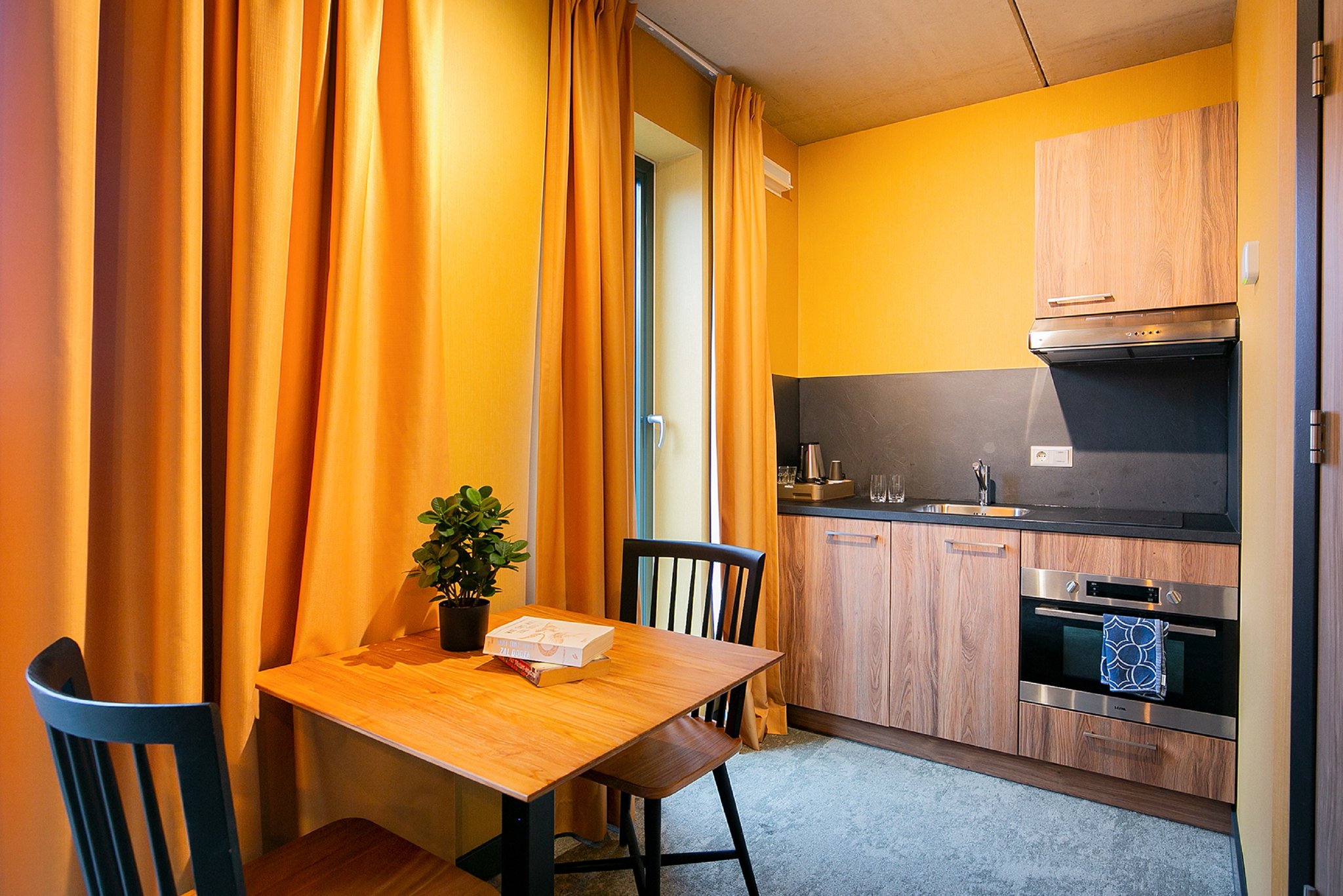 Deluxe_Room_with_Kitchen_and_Balcony_Table_with_Kitchen_S
